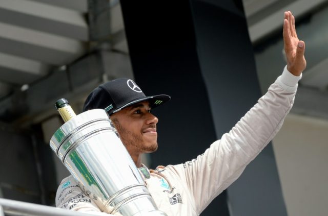 Mercedes AMG Petronas F1 Team's British driver Lewis Hamilton celebrates after winning at