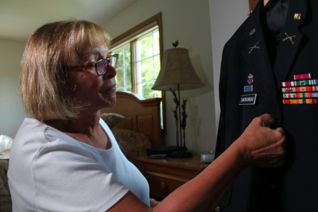 Transgender retired US Army colonel Sheri Swokowski prepares her uniform, at her home in D