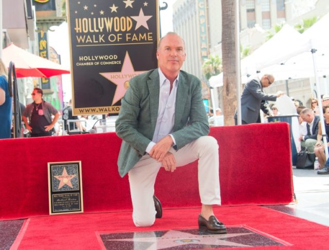 Actor Michael Keaton poses with his star on the Hollywood Walk of Fame on July 28, 2016