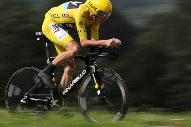 Great Britain's Chris Froome, wearing the overall leader's yellow jersey, rides in the 17k