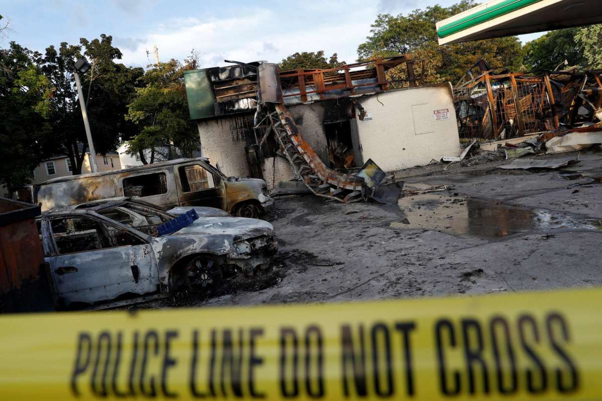 A gas station is seen burned down after disturbances following the police shooting of a man in Milwaukee, Wisconsin, U.S. August 14, 2016. REUTERS/Aaron P. Bernstein