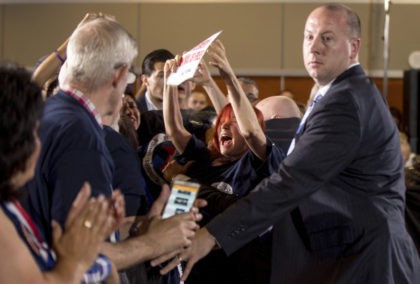 A animal rights protester is pushed back by members of the Secret Service after she attemp