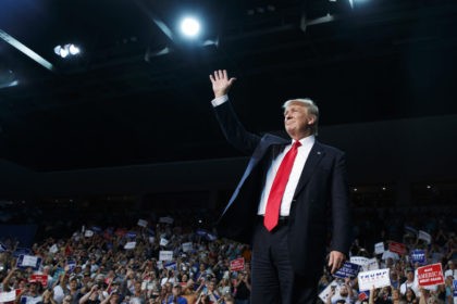 Republican presidential candidate Donald Trump waves as he arrives for a campaign rally, F