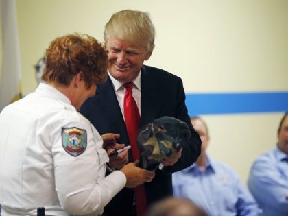 Republican presidential candidate Donald Trump smiles while autographing a hat as he speaks to retired and active law enforcement personnel at a Fraternal Order of Police lodge during a campaign stop in Statesville, N.C., Thursday, Aug. 18, 2016. (AP Photo/Gerald Herbert)