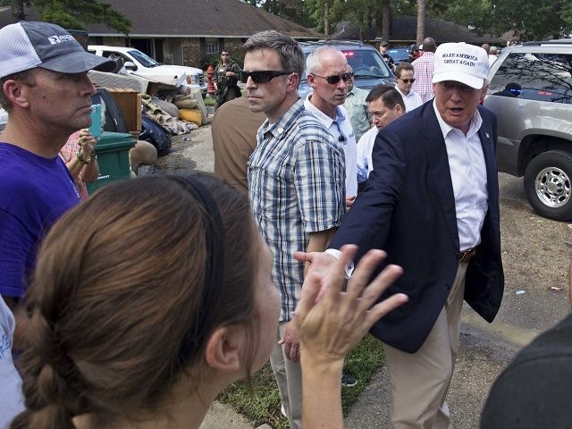 Republican presidential candidate Donald Trump greets flood victims during a tour of flood