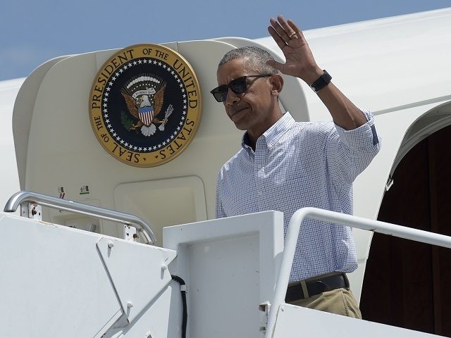 President Barack Obama waves as he steps off Air Force One at Baton Rouge Metropolitan Air