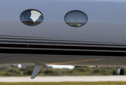 Democratic presidential candidate Hillary Clinton is seen silhouetted in the window of her campaign plane as she arrives at Nantucket Memorial Airport in Nantucket, Mass., Saturday, Aug. 20, 2016., en route to a fundraiser. (AP Photo/Carolyn Kaster)