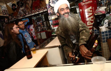 SAO PAULO, BRAZIL - APRIL 29: Osama bin Laden lookalike Ceara Francisco Helder Braga Fernandes (R) serves customers in his 'Bar do Bin Laden' on April 29, 2014 in Sao Paulo, Brazil. Braga says he was known as the 'Beard Man' before 9/11 but became known as a Bin Laden …