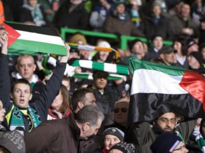 Celtic supporters and demonstrators show support for Palestinians at the match between Hapoel Tel Aviv and Celtic, during their European League football match at Celtic Park, in Glasgow, Scotland, on December 2, 2009. AFP PHOTO / DEREK BLAIR (Photo credit should read Derek Blair/AFP/Getty Images)
