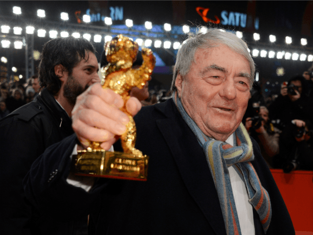 French director Claude Lanzmann poses with his honoury Golden Bear on the red carpet for t