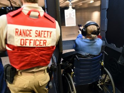 A woman on a wheelchair fires a handgun at the RTSP shooting range in Randolph, New Jersey