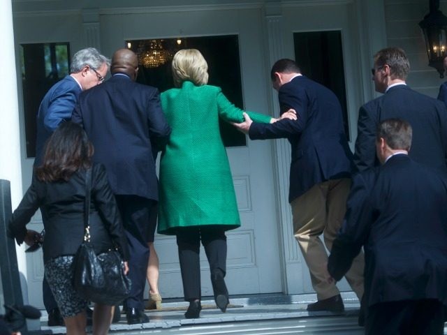 Democratic Presidential candidate, former Secretary of State Hillary Clinton slips as she walks up the stairs into the non-profit SC Strong, a 2 year residential facility that helps former felons, substance abusers, and homeless move into self-sufficiency February 24, 2016 in North Charleston.