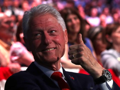 BROOKLYN, NY - JUNE 07: Former U.S. president Bill Clinton (R) gives the thumbs-up to his daughter Chelsea Clinton as his wife, Democratic presidential candidate former Secretary of State Hillary Clinton, speaks during a primary night event on June 7, 2016 in Brooklyn, New York. Hillary Clinton surpassed the number …