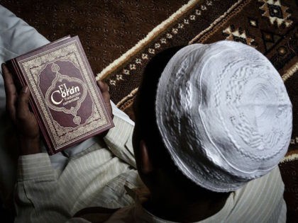 A Muslim Cuban man reads the Koran at the Abdallah mosque during Ramadan in Havana, on July 1, 2016. The small Muslim community of Cuba celebrates discreetly the end of its Ramadan. / AFP / ADALBERTO ROQUE / TO GO WITH AFP STORY BY ROMANE FRACHON (Photo credit should read …