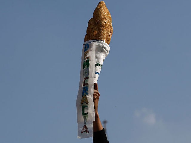 TOPSHOT - Supporters of Brazilian suspended President Dilma Rousseff take part in a protest against interim president Michel Temer, in Sao Paulo, Brazil on July 31, 2016. Protesters took to the streets of Brazil on Sunday to demand the final leaving of suspended President Dilma Rousseff or to defend her continuance, just five days before the start of the Rio 2016 Olympic Games. / AFP / Miguel Schincariol (Photo credit should read MIGUEL SCHINCARIOL/AFP/Getty Images)