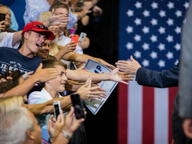 Supporters reach out to Republican presidential nominee Donald Trump after a rally at the