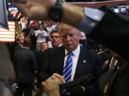 Republican presidential nominee Donald Trump signs an autograph as he greets people during