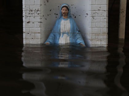 ST AMANT, LA - AUGUST 18: A Virgin Mary statue is seen in front of a flooded home on August 18, 2016 in St Amant, Louisiana. Last week Louisiana was overwhelmed with flood water causing at least thirteen deaths and thousands of homes damaged by the flood waters. (Photo by …