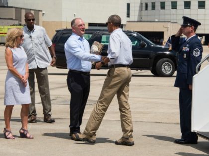 S President Barack Obama is greeted by Louisiana Governor John Bel Edwards and his wife Donna at Baton Rouge Metropolitan Airport in Baton Rouge, Louisiana, on August 23, 2016. Fresh from a two-week vacation, President Barack Obama visits flood-hit Louisiana, hoping to offer support to devastated communities and silence his …