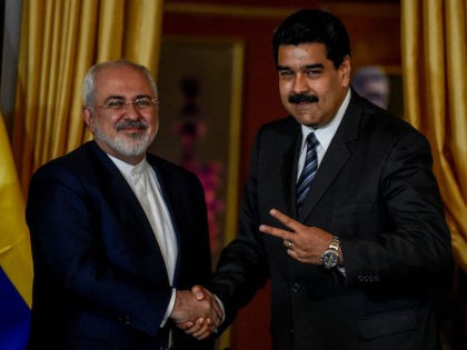 Venezuela's President Nicolas Maduro (R) and Iranian Foreign Minister Mohammad Javad