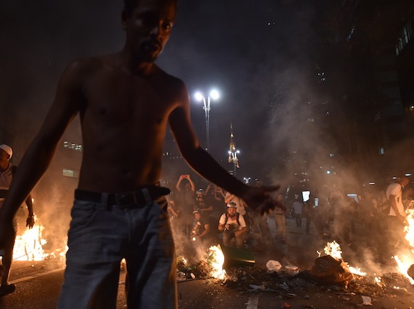 Supporters of suspendend president Dilma Rousseff holding a demonstration during her impeachment trial set trash bags on fire as police fire tear gas grenades at them, in Sao Paulo Brazil on August 29, 2016. Rousseff who testified for the first time at her trial urged the Senate to vote against impeaching her denying charges that she fiddled government accounts. / AFP / NELSON ALMEIDA (Photo credit should read NELSON ALMEIDA/AFP/Getty Images)