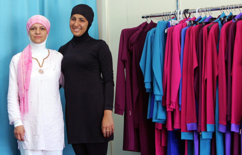 Sydney, AUSTRALIA: Muslim fashion designer Aheda Zanetti (L) stands beside Australian model Mecca Laalaa (R) wearing her Islamic swimsuit at the Islamic Sport and Swimwear shop in Sydney, 12 January 2007. The new "Burqini" is marketed as the first two-piece Muslim swimwear for women and is attracting customers from North America, Europe and across the Middle East. AFP PHOTO/Anoek DE GROOT (Photo credit should read ANOEK DE GROOT/AFP/Getty Images)