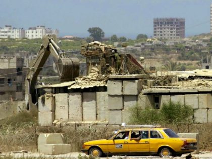 NETZARIM JUNCTION, GAZA STRIP - JULY 31: In this handout photo from the Israeli Military, a Palestinian taxi drives past July 31, 2003 as the army's outpost at the Netzarim junction in Gaza is dismantled. Israel and the Palestinians failed to reach an agreement on the transfer of further West …