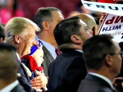 Republican presidential candidate Donald Trump holds a baby during a rally in Charleston,