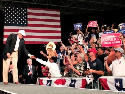 DIMONDALE, MI - AUGUST 19: Republican presidential nominee Donald Trump shakes hands with supporters on his way to the podium to speak at a campaign rally August 19, 2016 in Dimondale, Michigan. Earlier in the day, Trump toured flood-ravaged Louisiana. (Photo by Bill Pugliano/Getty Images) *** TRUMP ***