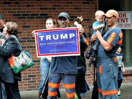 Coal miner Chris Steele holds a sign supporting Donald Trump outside a Democratic presidential candidate Hillary Clinton event in Williamson, W.V., Monday, May 2, 2016. (AP Photo/Paul Sancya)