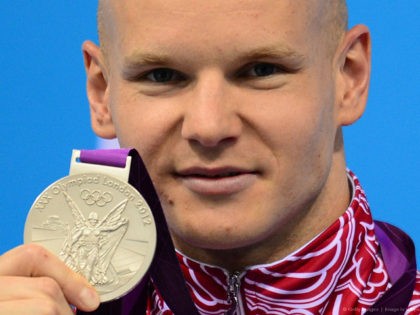 Russia's Evgeny Korotyshkin poses on the podium with his medal after winning silver in the men's 100m butterfly final swimming event at the London 2012 Olympic Games on August 3, 2012 in London. AFP PHOTO / MARTIN BUREAU (Photo credit should read MARTIN BUREAU/AFP/GettyImages)