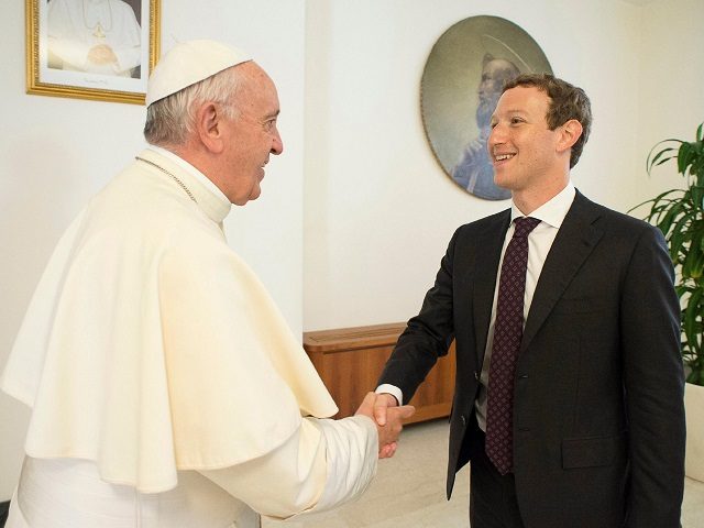 Pope Francis shakes hands with Facebook CEO Mark Zuckerberg during a meeting at the Vatica
