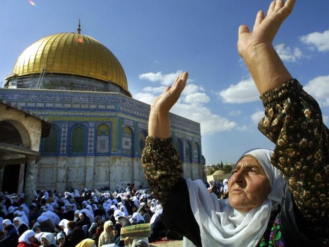 A Palestinian woman joins some 10,000 Palestinians in prayer at Jerusalem's Al-Aqsa mosque