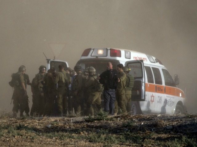 Israeli soldiers evacuate their wounded comrades at an army deployment area along the Israeli border with the Gaza Strip on July 28, 2014. The Israeli army said five of its soldiers have been killed in and around the wartorn Gaza Strip. AFP PHOTO / JACK GUEZ (Photo credit should read …