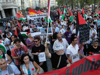 DEMONSTRATORS MARCH with Palestinian flags during a protest against the Israeli offensive against Gaza, in Valencia, Spain. (photo credit:REUTERS)