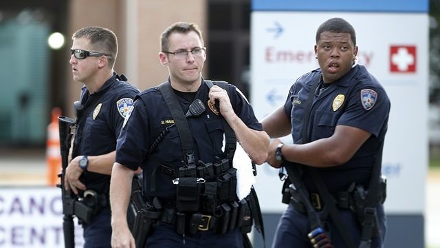 Police guard the emergency room entrance of Our Lady of the Lake Medical Center, where wounded officers were brought Sunday in Baton Rouge, La.