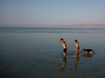 Israelis enjoy the Dead Sea on April 7, 2015. Thousands of Israelis spent the day outdoors, picnicking and touring the country during the eight-day Passover holiday, which commemorates the Israelites' exodus from Egypt some 3,500 years ago. AFP PHOTO/MENAHEM KAHANA (Photo credit should read MENAHEM KAHANA/AFP/Getty Images)