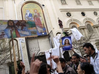 Egyptian Christians protest outside the Al-Qiddissine (The Saints) church following an overnight car bomb attack on the church in the Egyptian port city of Alexandria on January 1, 2011 which killed 21 people, hitting Egypt's Christian community, the biggest in the Middle East. AFP PHOTO/MOHAMMED ABED (Photo credit should read …