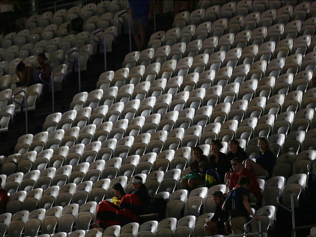 RIO DE JANEIRO, BRAZIL - AUGUST 08: People watch a match amongst empty seats at the Olympi