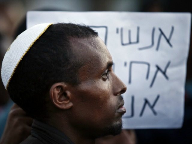 An Ethiopian Israeli protestor wears a kippah, the traditional Jewish skullcap for men, during a demonstration in a street of the Israeli city of Kiryat Gat on May 4, 2015. Israel pledged to crack down on racism and discrimination against Ethiopian Jews as officials sought to ease tensions after a …