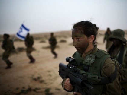 Israeli female soldiers of the 33rd Caracal Battalion take part in a graduation march in the northern part of the southern Israeli Negev desert, on March 13 2013. The Caracal unit is an infantry combat battalion of the army, composed of both male and female soldiers mostly serving along the …