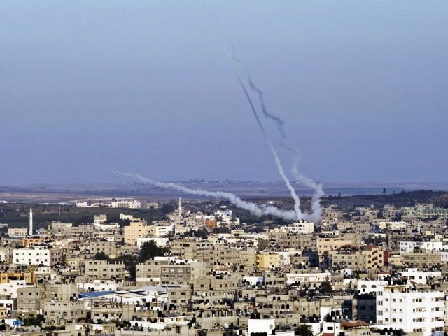 Smoke trails mark the path of Palestinian missiles fired from the north-east of Gaza City on August 21, 2014. As the sixth week war between Israel and Hamas raged on, leaving Egyptian mediated truce talks in tatters, warplanes continued to pound Gaza killing three members of the Islamist movement's armed …