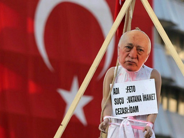 A picture taken on August 2, 2016 shows a picture of US-based preacher Fethullah Gulen set up on a dummy at the Kizilay Square in front of a Turkish national flag in Ankara during a protest against the failed military coup, on August 2, 2016. Erdogan said on August 2, …