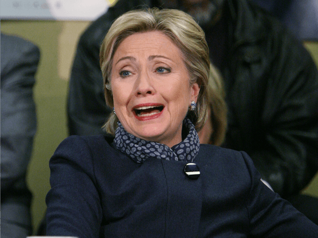 Democratic presidential hopeful Sen. Hillary Clinton (D-NY) laughs while listening to a gr
