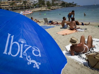 People sunbathe on the Figueretes Beach on Ibiza island on July 9, 2015. AFP PHOTO / JAIME REINA (Photo credit should read JAIME REINA/AFP/Getty Images)
