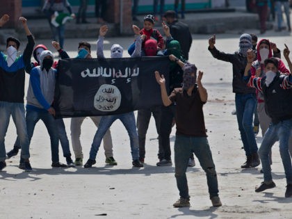 Kashmir Muslim protesters hold a flag of Islamic State as they shout anti-India slogans during a protest in Srinagar, Indian controlled Kashmir, Friday, April 8, 2016. Police fired teargas and pellet guns to disperse Kashmiris who gathered after Friday afternoon prayers to protest against Indian control over a part of …