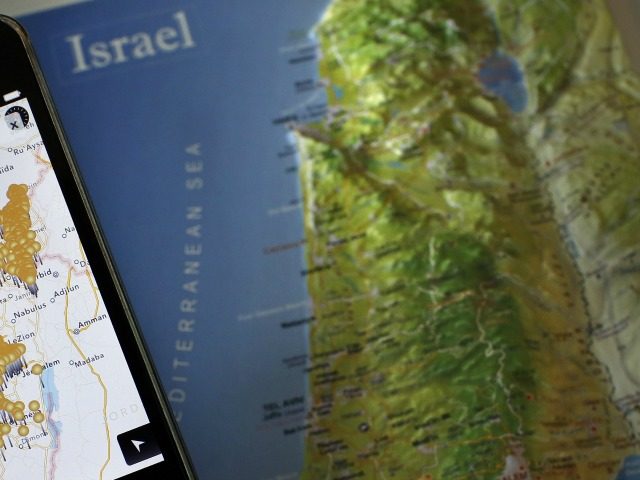 A photo taken on May 5, 2014 shows a smartphone placed on an Israeli map in Jerusalem, dis