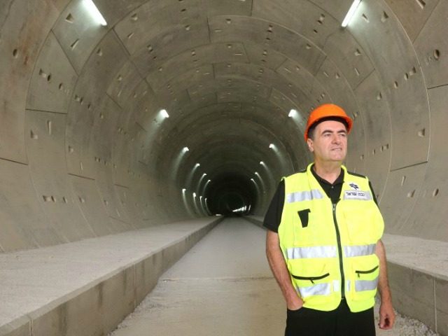 Transportation Minister Yisrael Katz stands at one of the five tunnels dug to accommodate