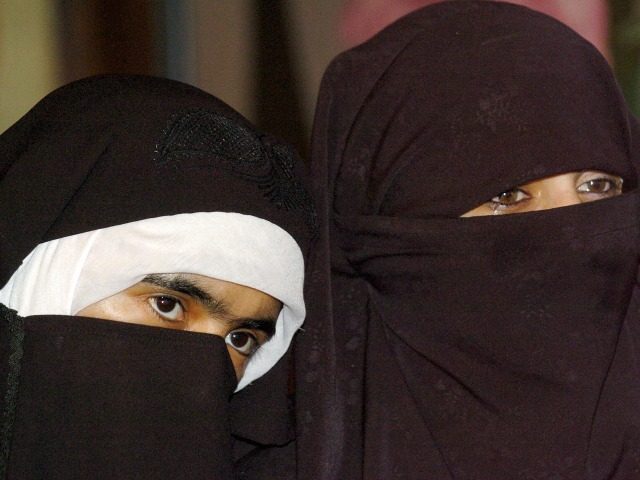 Veiled Indian Kashmiri Muslim activists of the Dukhtaran-e-Milat (Daughters of the Faith) organization look on during a press confrence held to urge the government to reveal the names of people caught up in a prostitution scandal in Srinagar, 10 May 2006. Police in April 2006 unearthed an alleged racket involving …