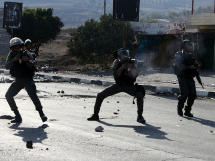 Israeli border guards take aim at Palestinian demonstrators (unseen) during clashes at the Hawara checkpoint, south of the West Bank city of Nablus on October 16, 2015. Palestinians called for a 'Friday of revolution' against Israel, as Jews armed themselves with everything from guns to broomsticks, rattled by a wave …